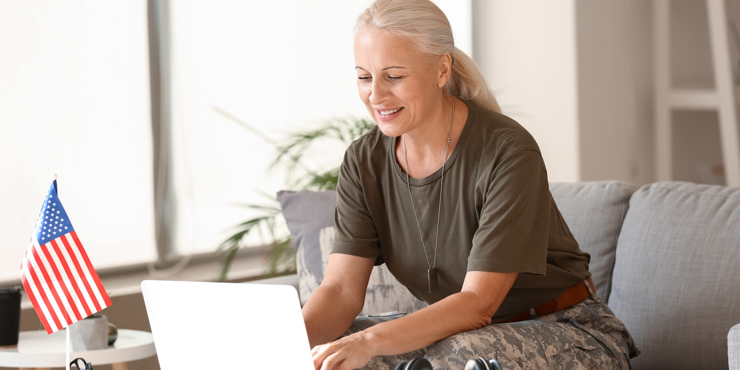 older woman in military uniform on a computer new sign-in